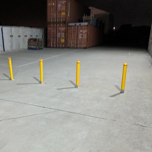 Stacked Shipping Containers and Security Bollards in Q Store yard