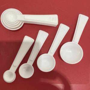 Set of white plastic measuring spoons